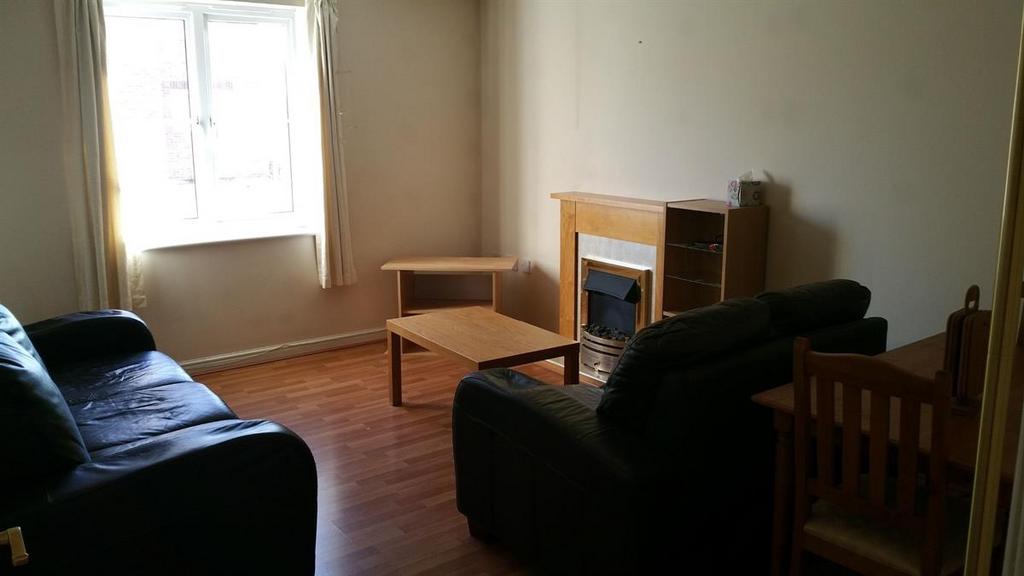Bright and simply furnished living room with pl...