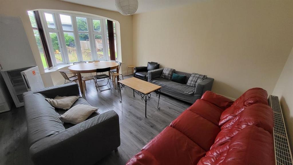 Bright, well-furnished living room with multipl...