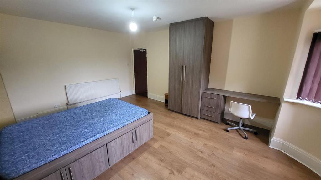 Bright, well-maintained bedroom featuring built...