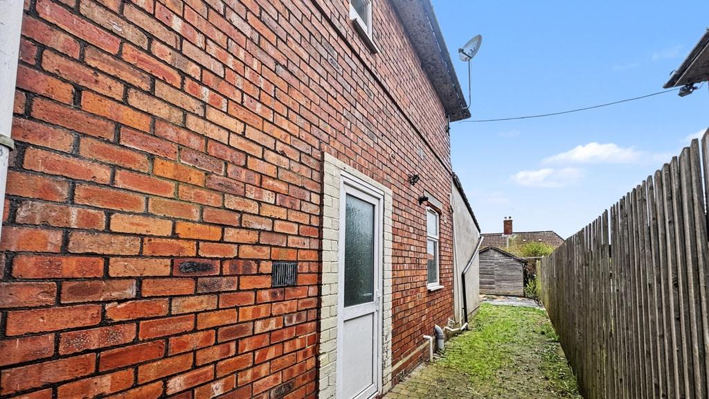 Crisp exterior side alley with brick façade, pr...