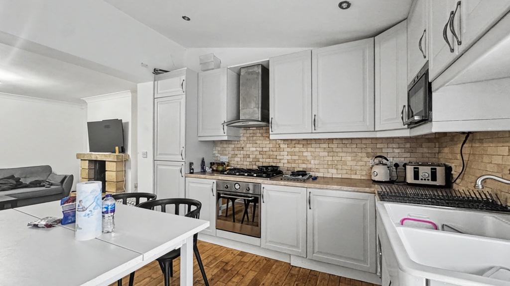 Bright, modern kitchen with light grey cabinetr...