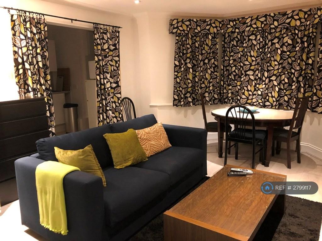 Lounge With Kitchen Behind At Night
