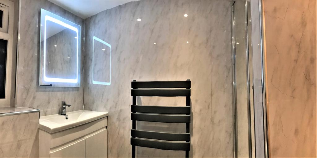 A stylish and modern bathroom featuring sleek m...