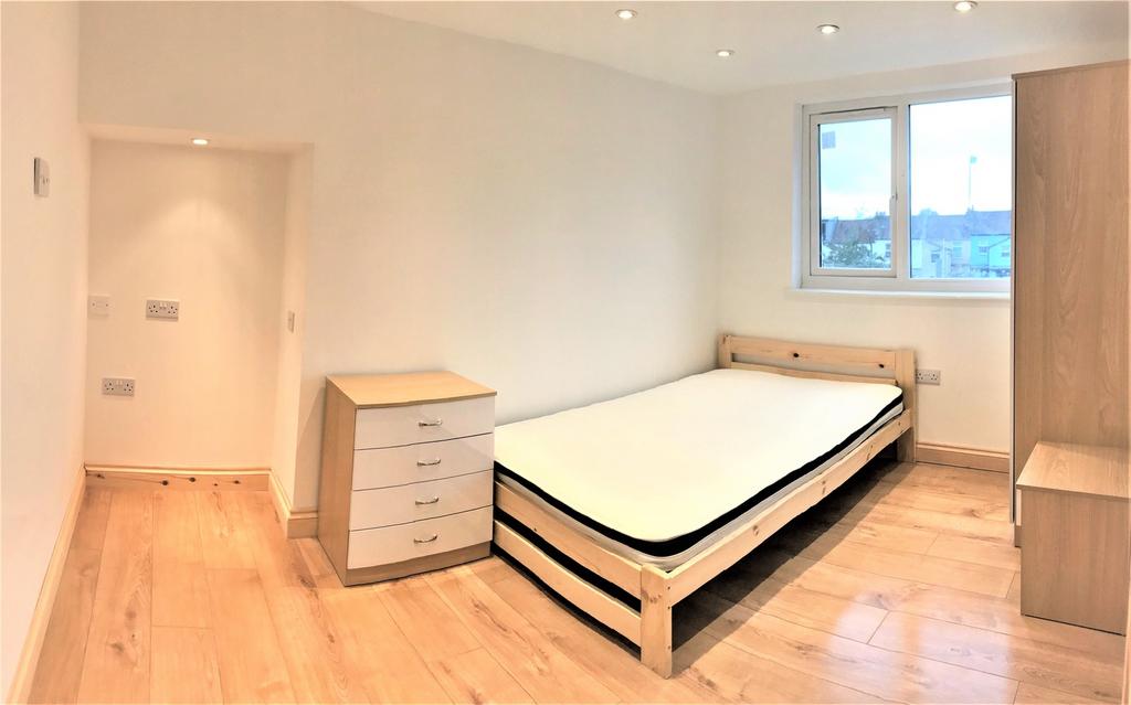 This spacious double bedroom features a contemp...