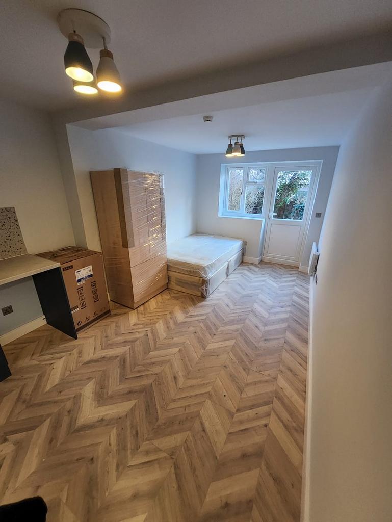 Bright, newly refurbished bedroom with chevron-...