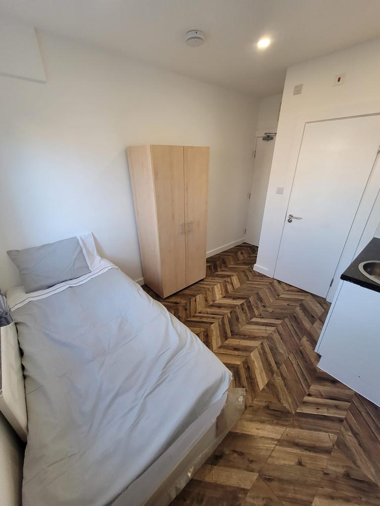 Bright, simply furnished single bedroom with a ...