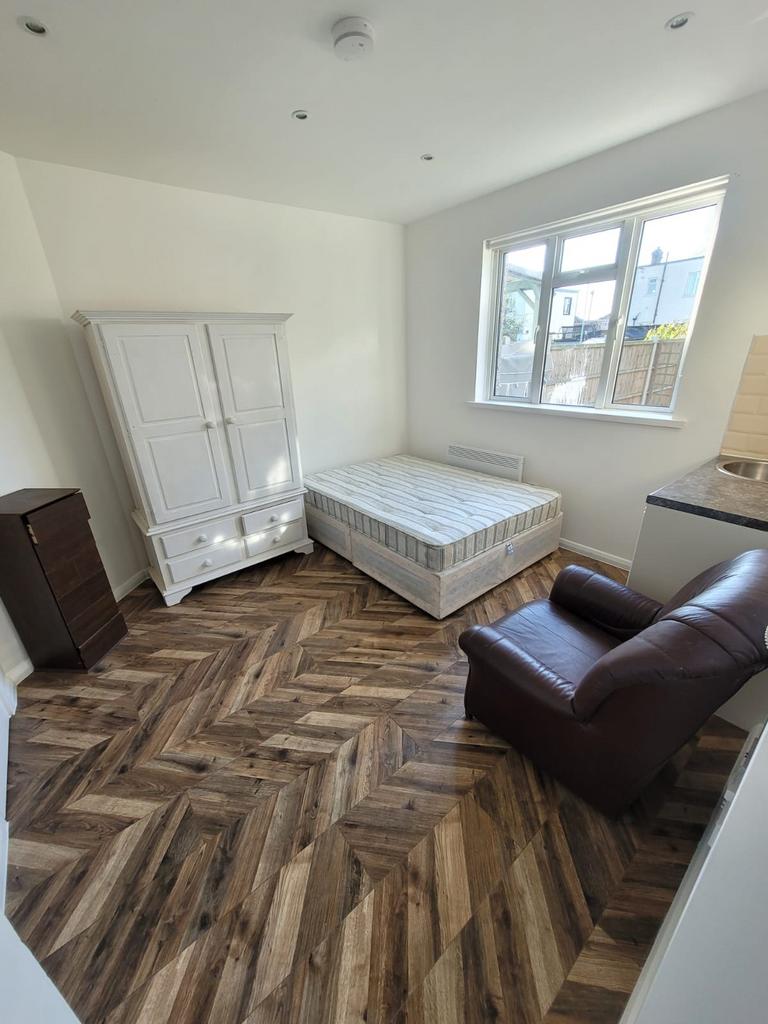 Bright double bedroom with a large window, styl...