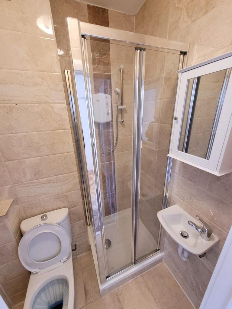 Well-presented tiled bathroom with a modern gla...