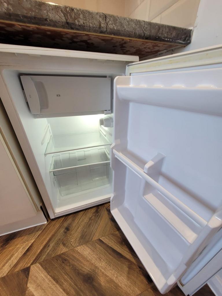 Compact under-counter refrigerator with a clean...