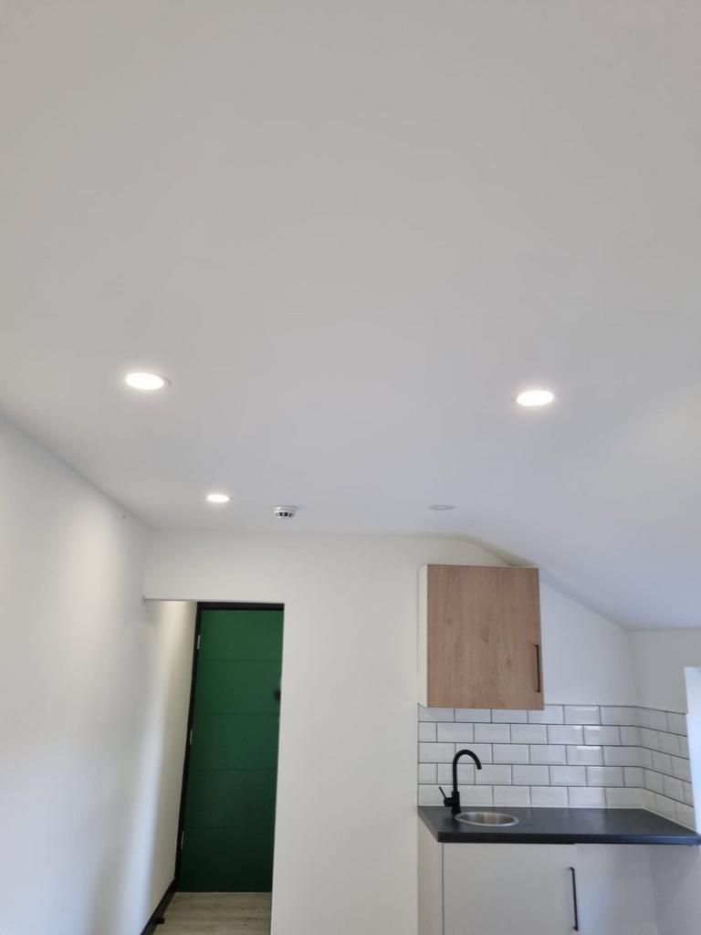 Modern kitchenette with white subway tile splas...