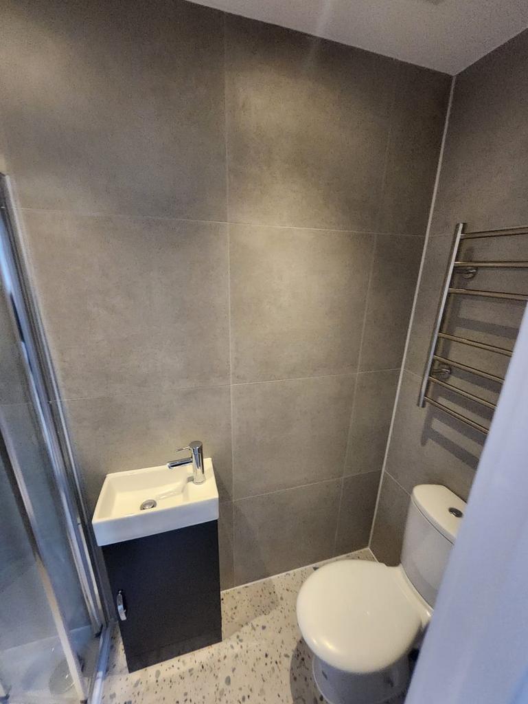 Compact modern bathroom with a wall-mounted tow...