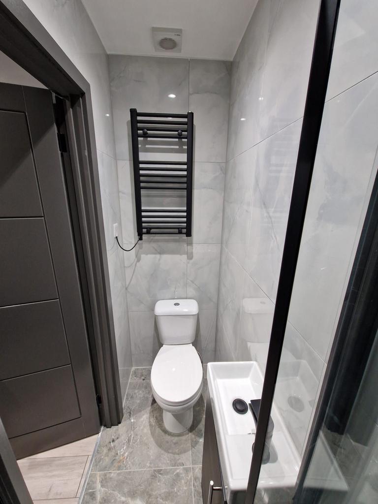 Contemporary tiled bathroom with a close-couple...