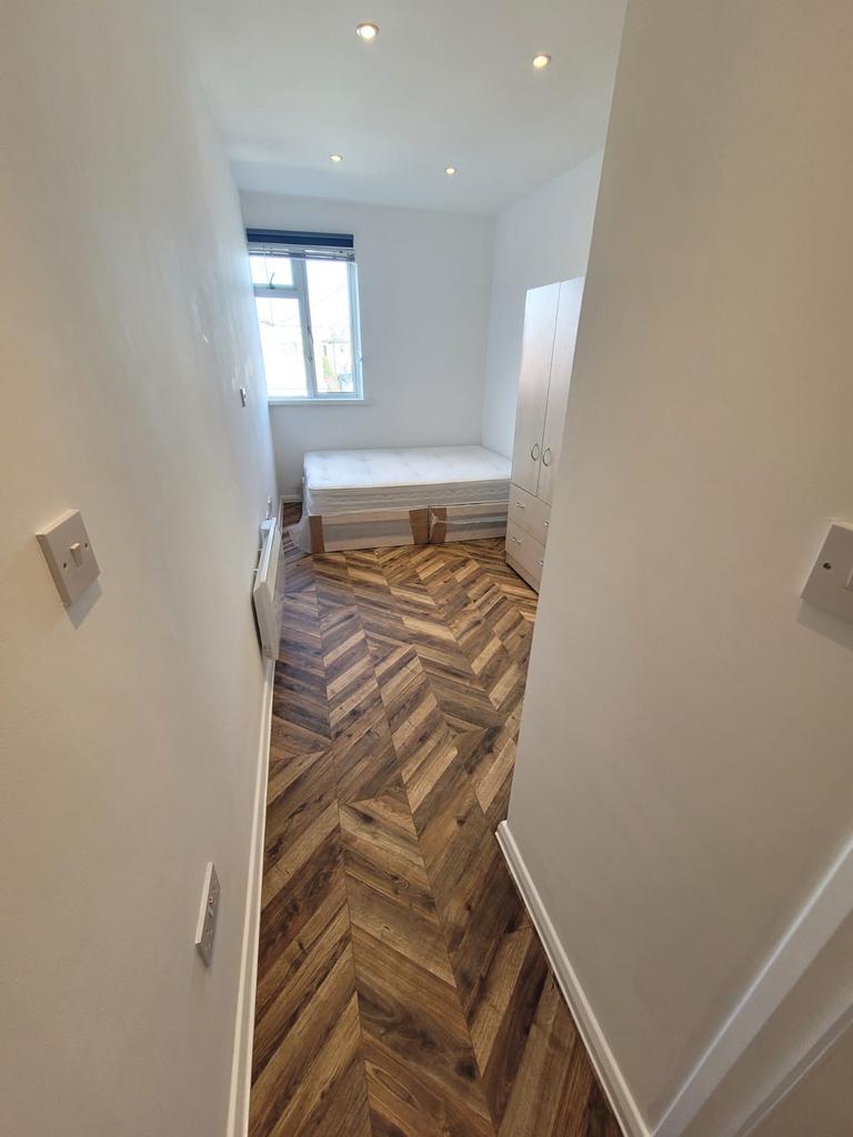 Bright, simply furnished single bedroom with a ...