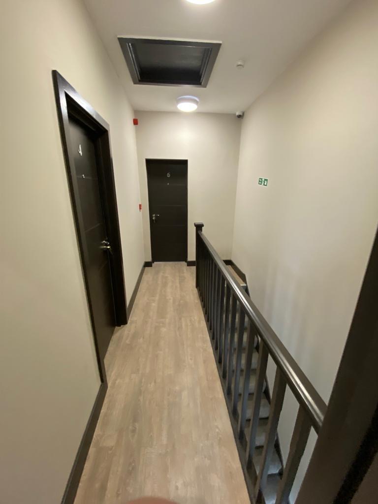 Well-maintained interior corridor with contempo...