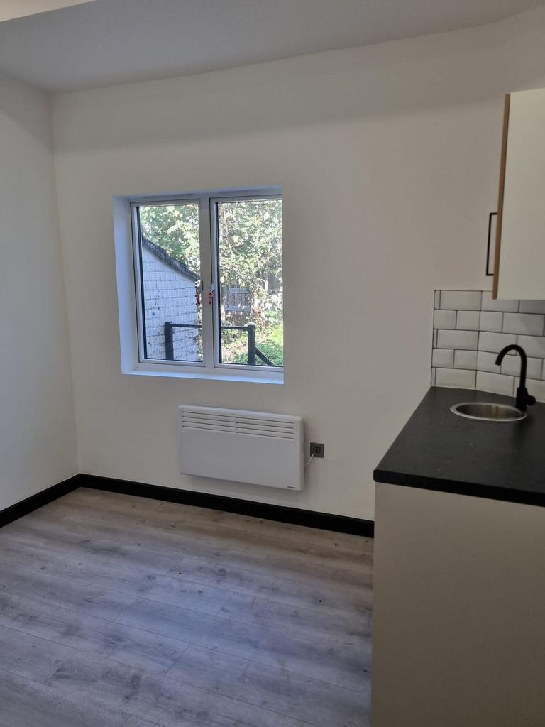 Compact modern kitchenette with a large window ...