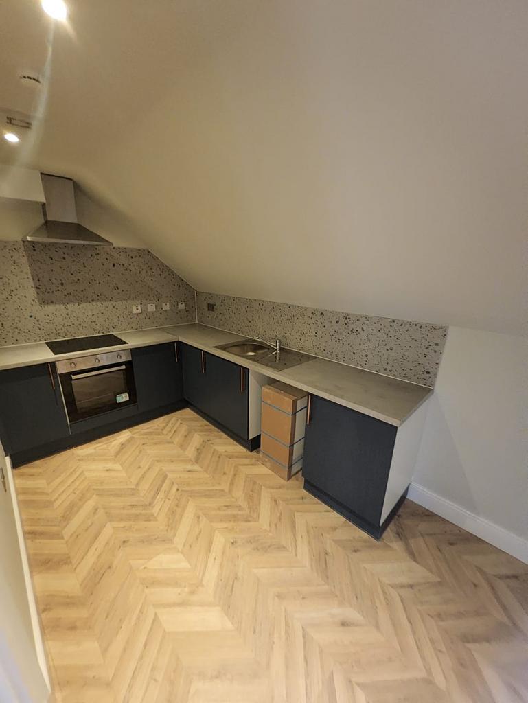 Modern fitted kitchen in a converted attic room...