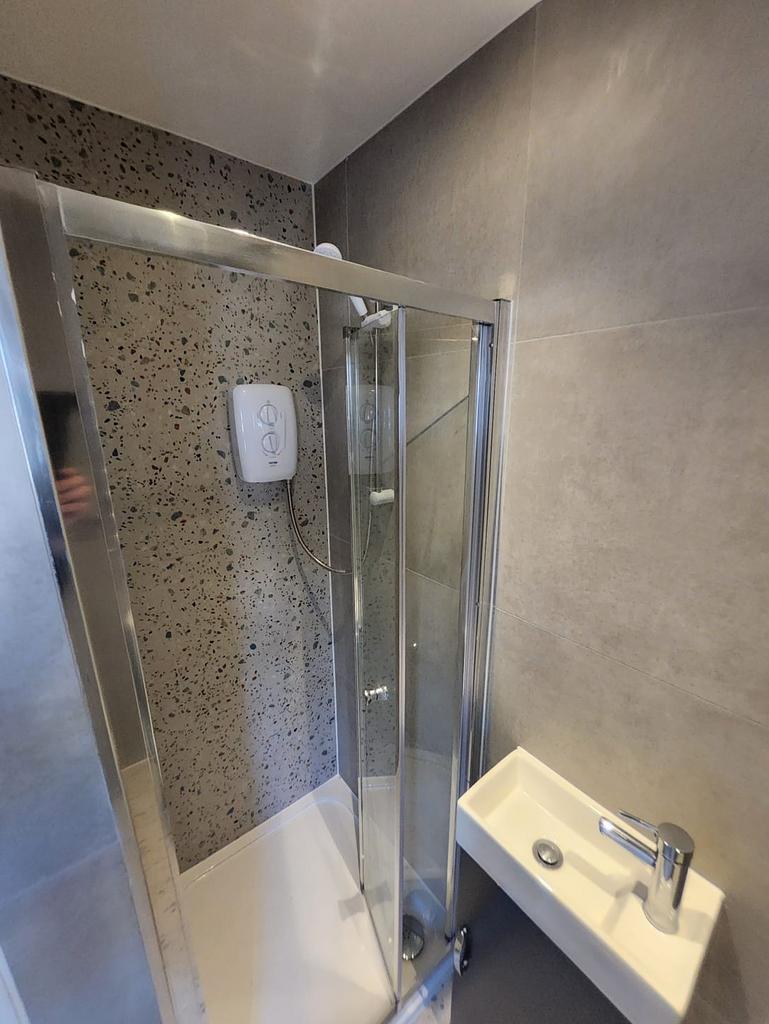Modern shower cubicle with glass sliding doors,...