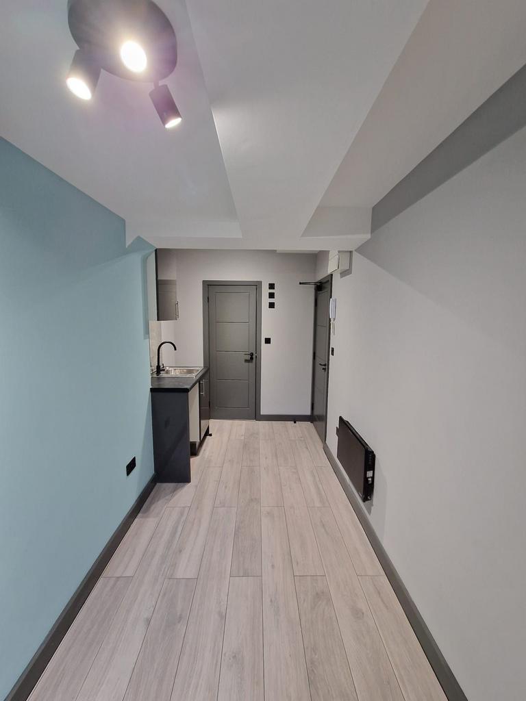 Bright, modern kitchenette with wood-effect flo...