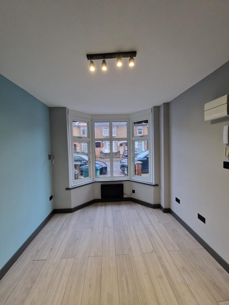 Bright, modern front living room with a bay win...