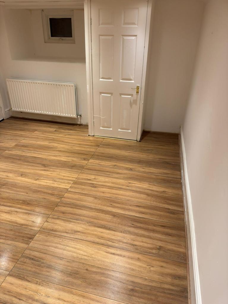 Neat, newly floored room with warm wood-effect ...