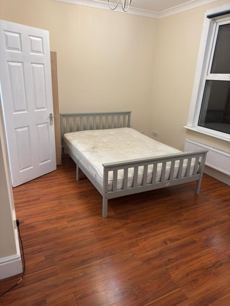 Bright, simply furnished double bedroom with a ...