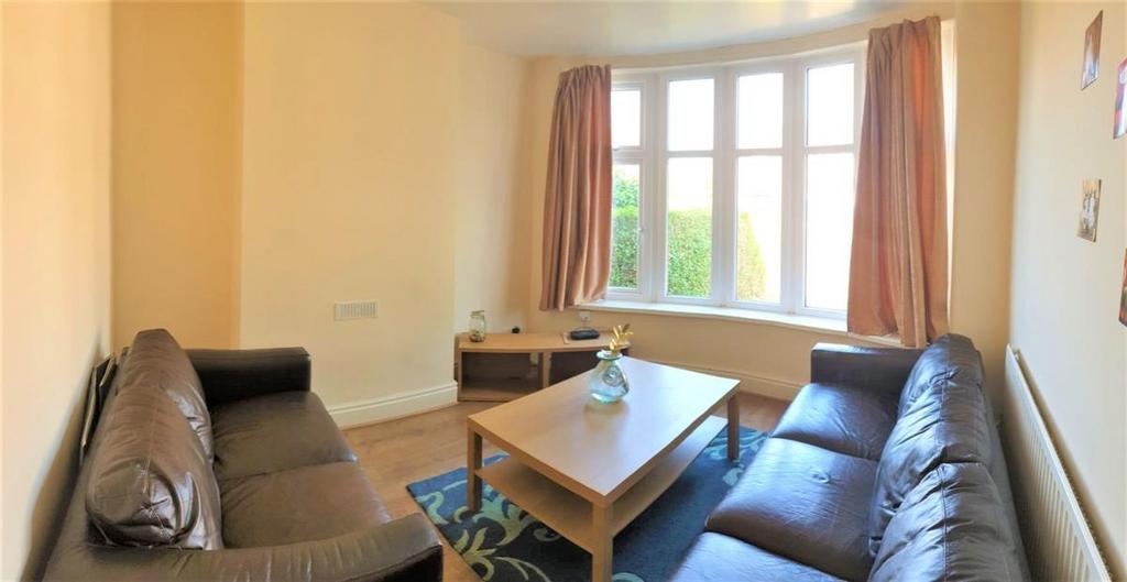 Bright, neutral living room with two sofas faci...