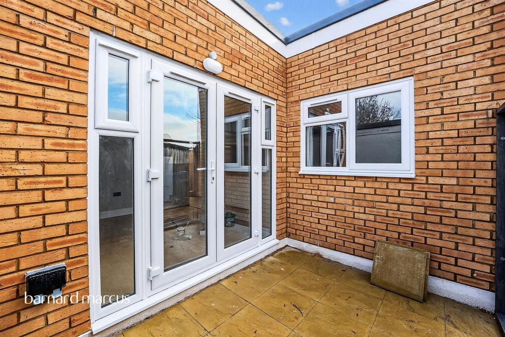 Conservatory interior, french doors leading to garden