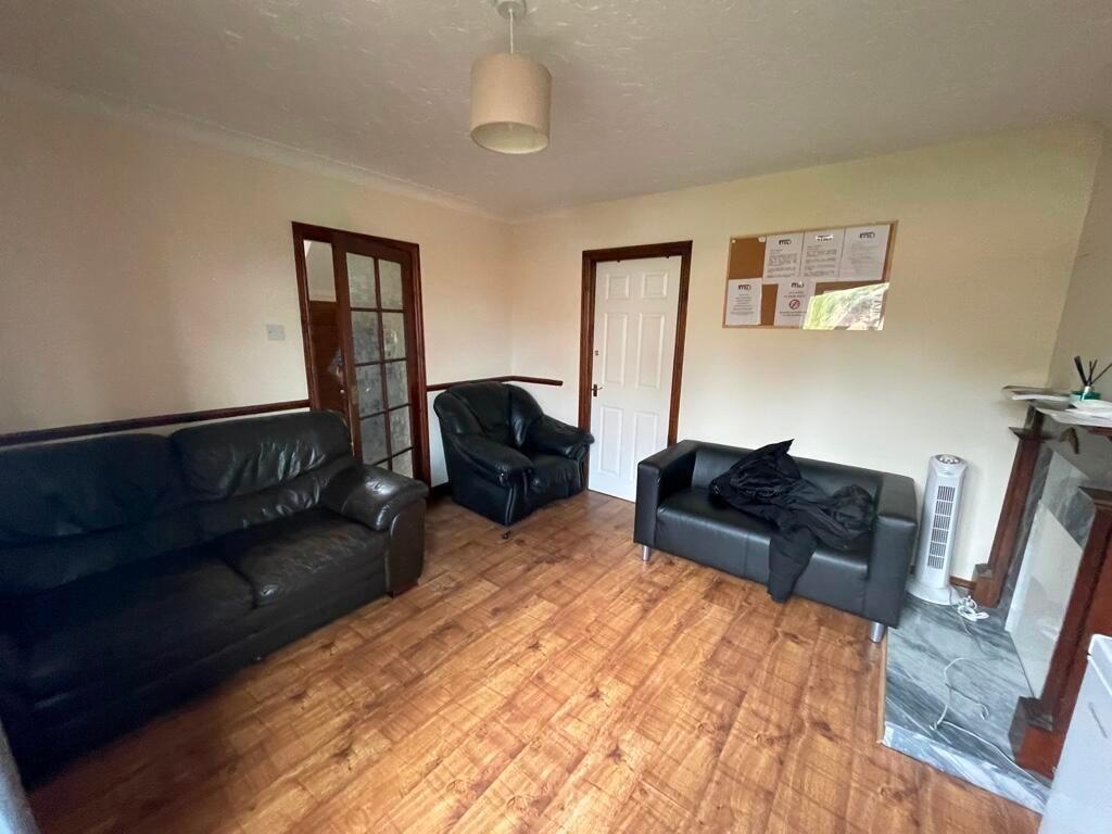 Bright, neutrally decorated living room with wo...