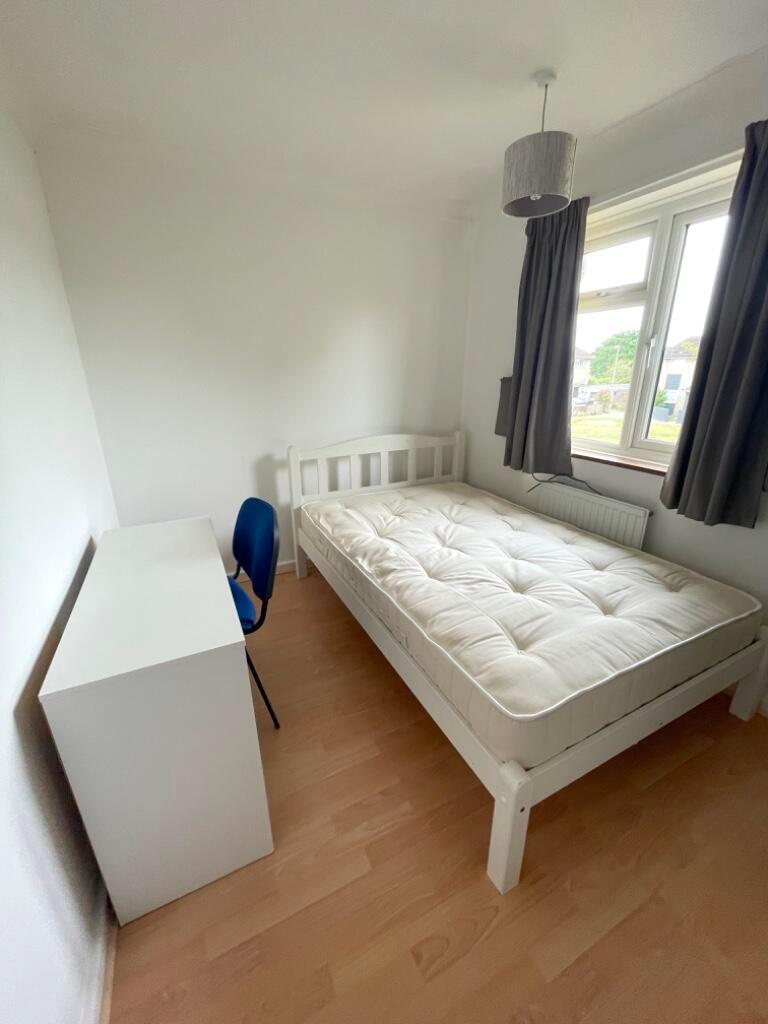 Bright, simply furnished single bedroom with a ...