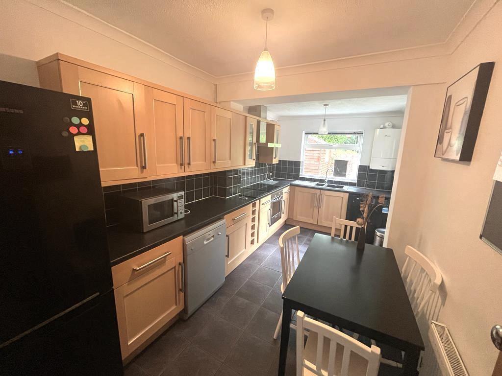 Bright, modern galley kitchen with ample cupboa...