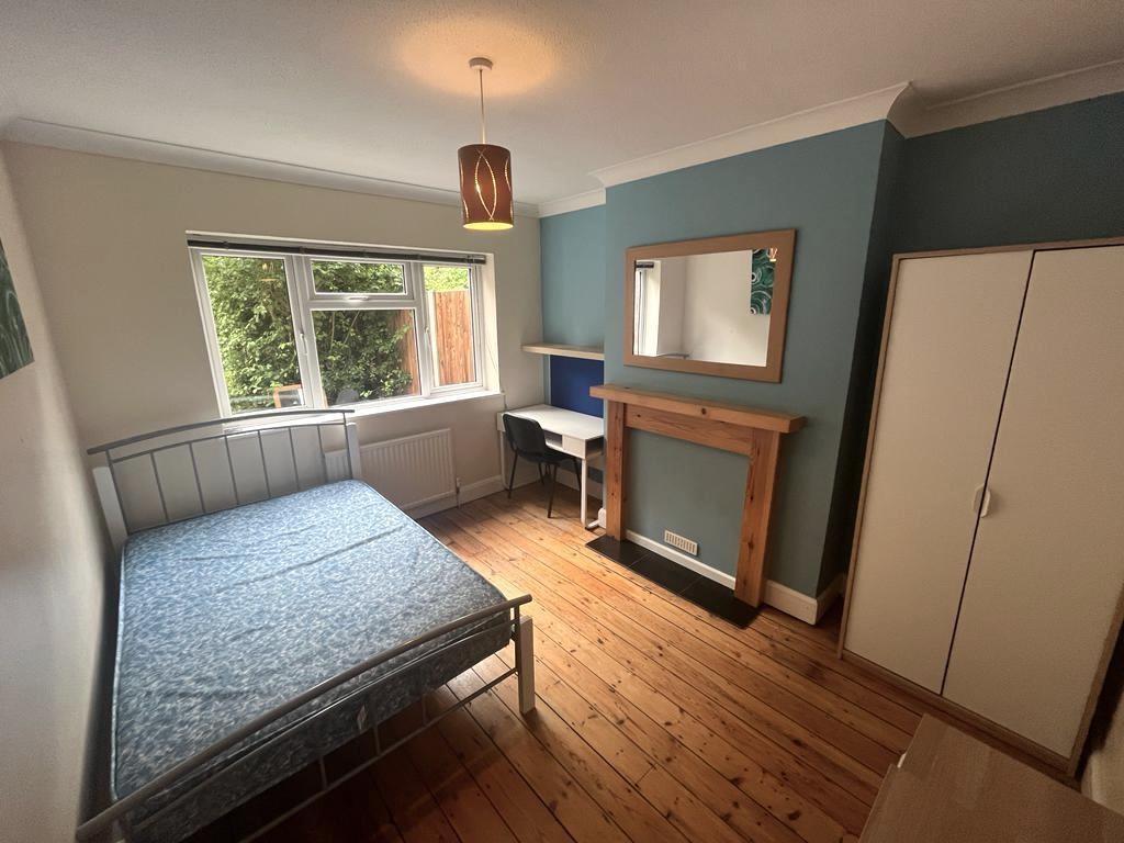 Bright, tidy bedroom with a double metal bed, w...