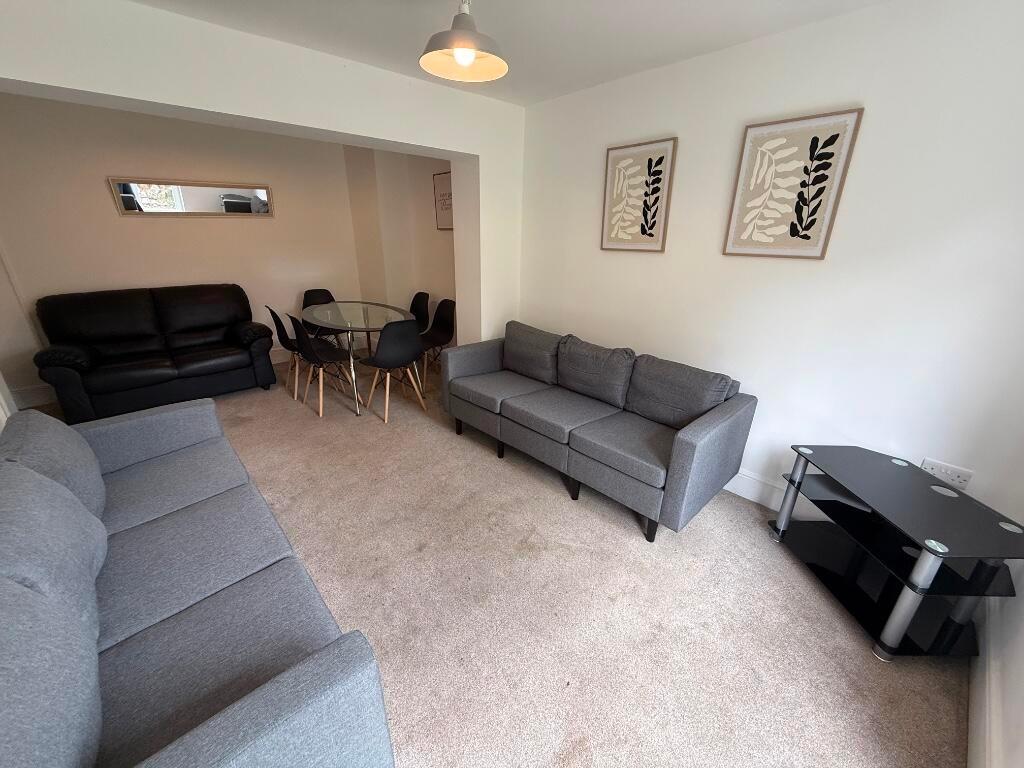 Bright, well-furnished living room with two com...