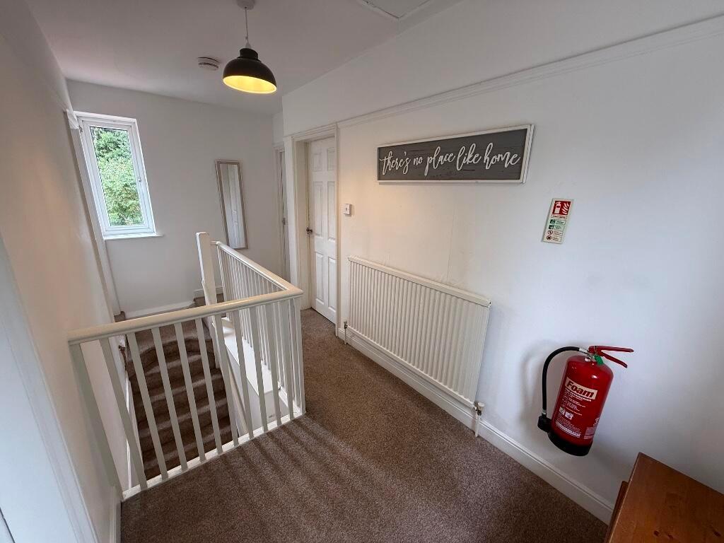 Bright first-floor landing with neutral decor, ...