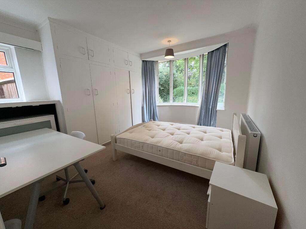 Bright, freshly painted double bedroom with bui...