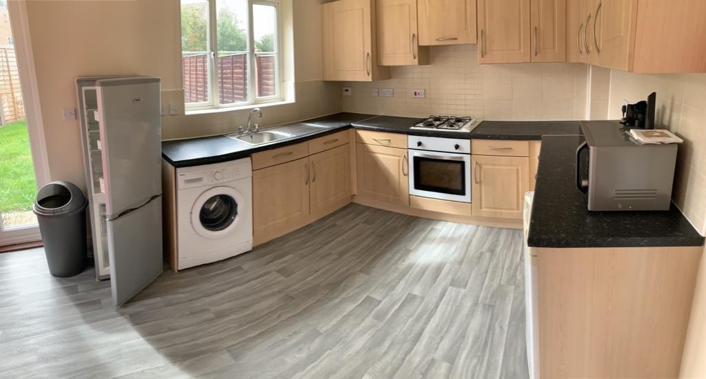 Bright, modern kitchen with L-shaped countertop...