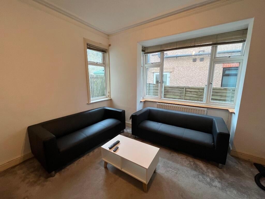 Bright, uncluttered living room with two matchi...