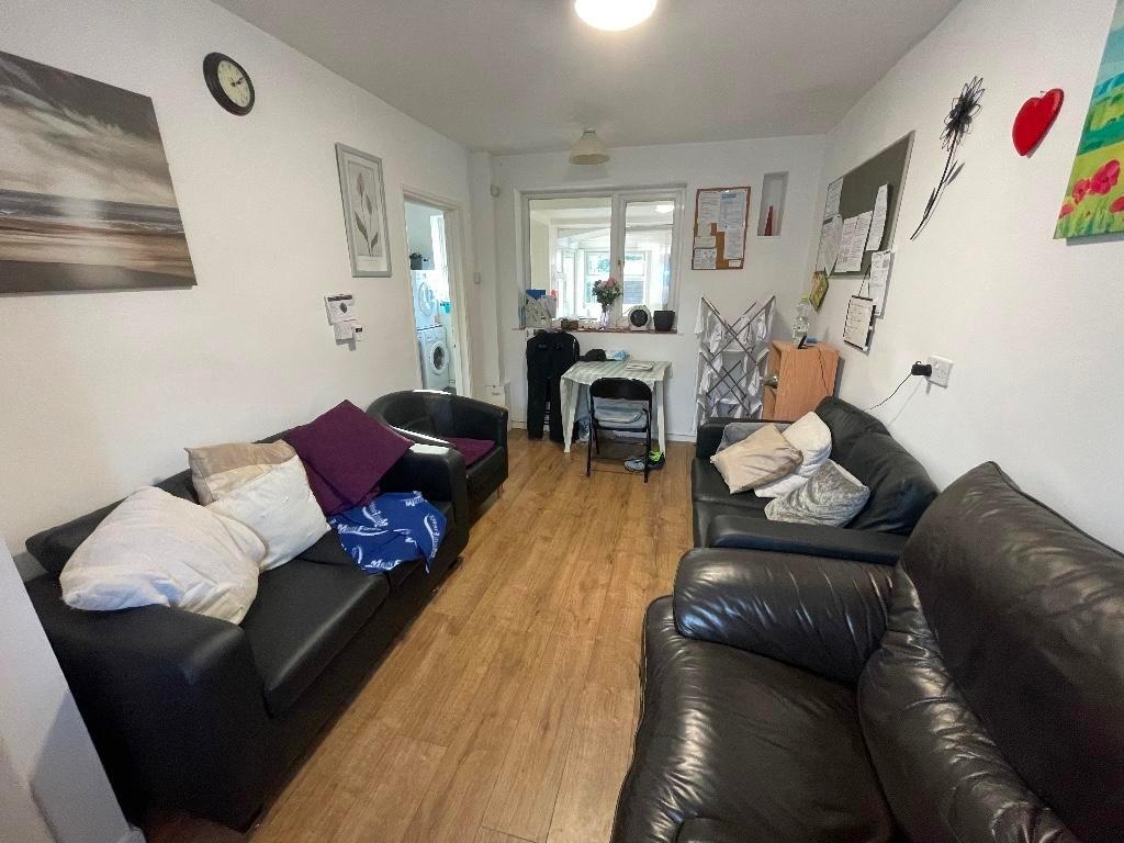 Bright, furnished communal living room with har...