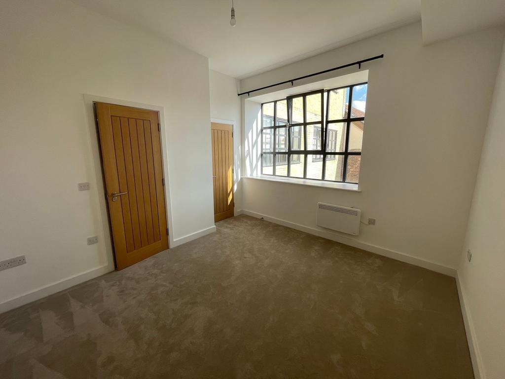 Bright, freshly decorated bedroom with a large ...