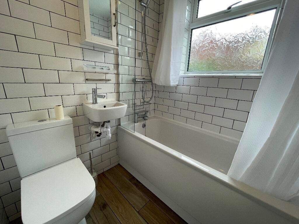 Bright, modern bathroom with white subway tiles...