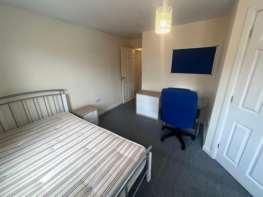Bright, neatly presented bedroom with a double ...