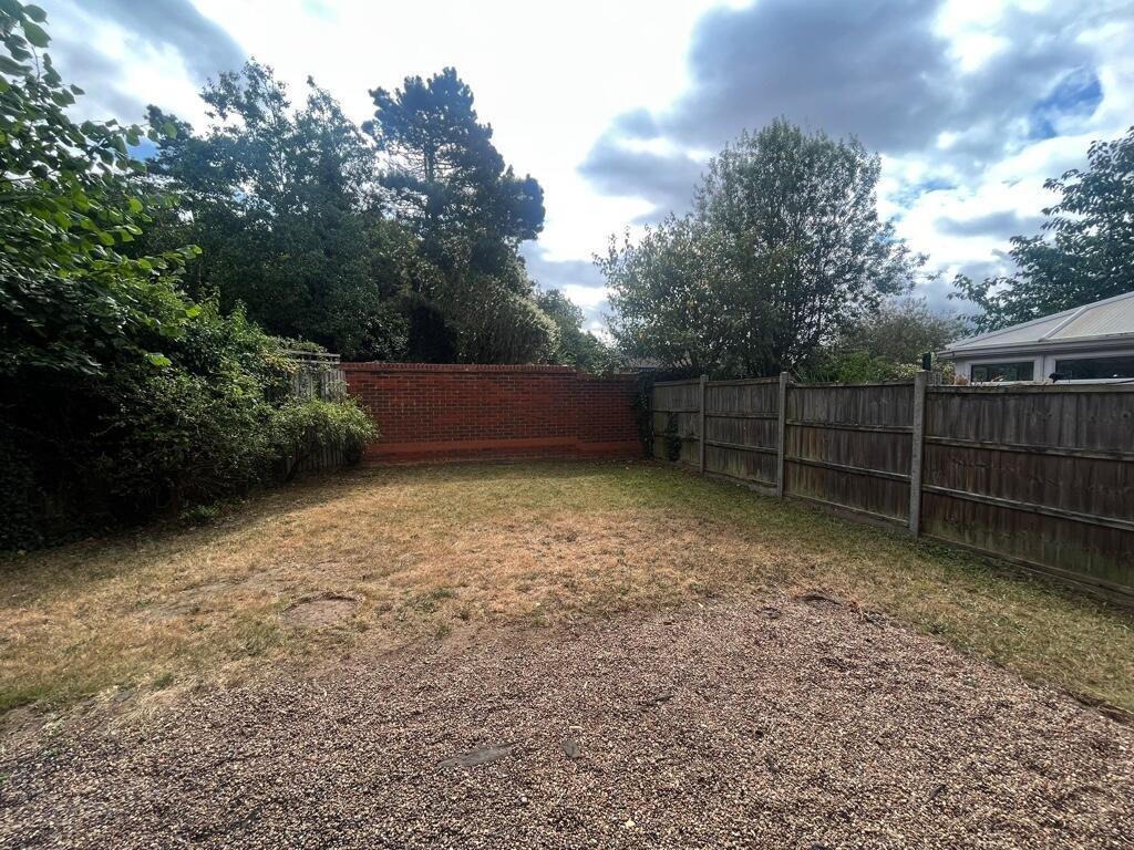 Private rear garden with a level lawn, mature b...