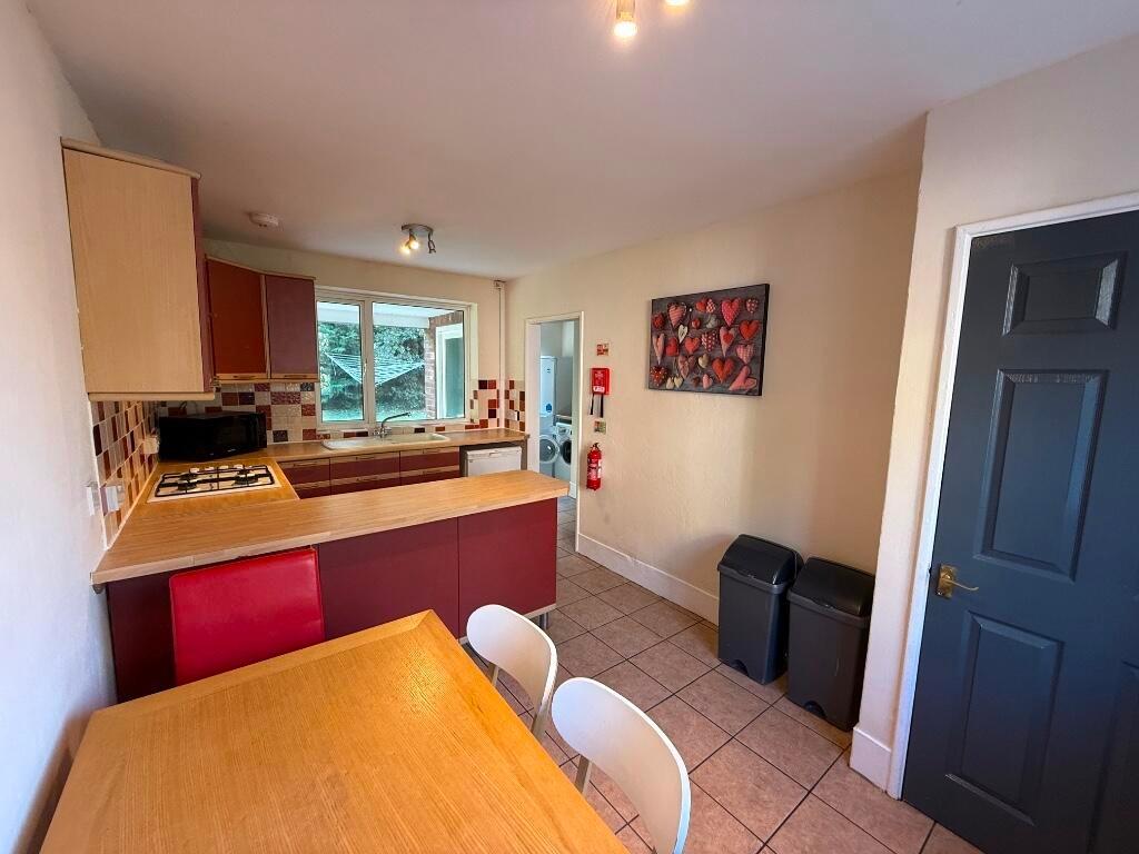 Bright, practical kitchen with a breakfast bar,...
