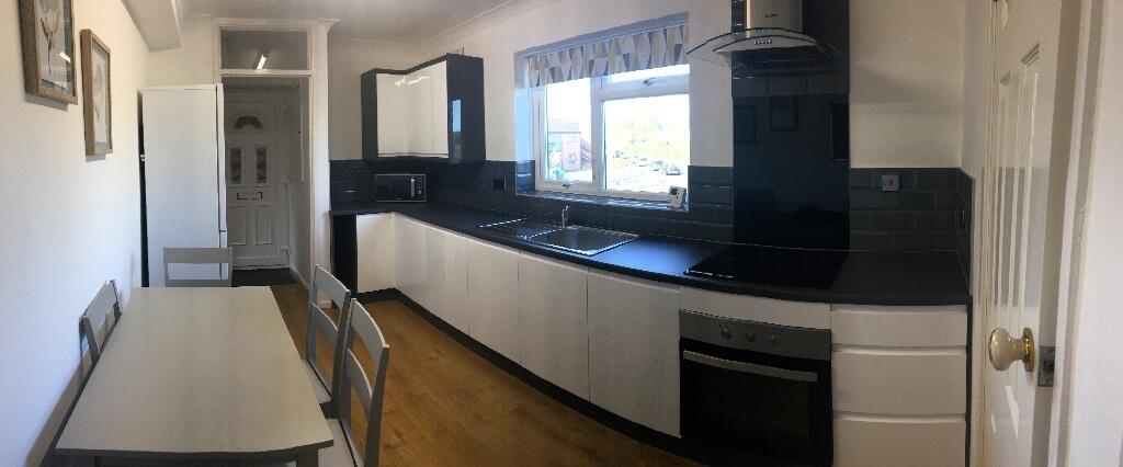 Bright contemporary galley kitchen with sleek b...