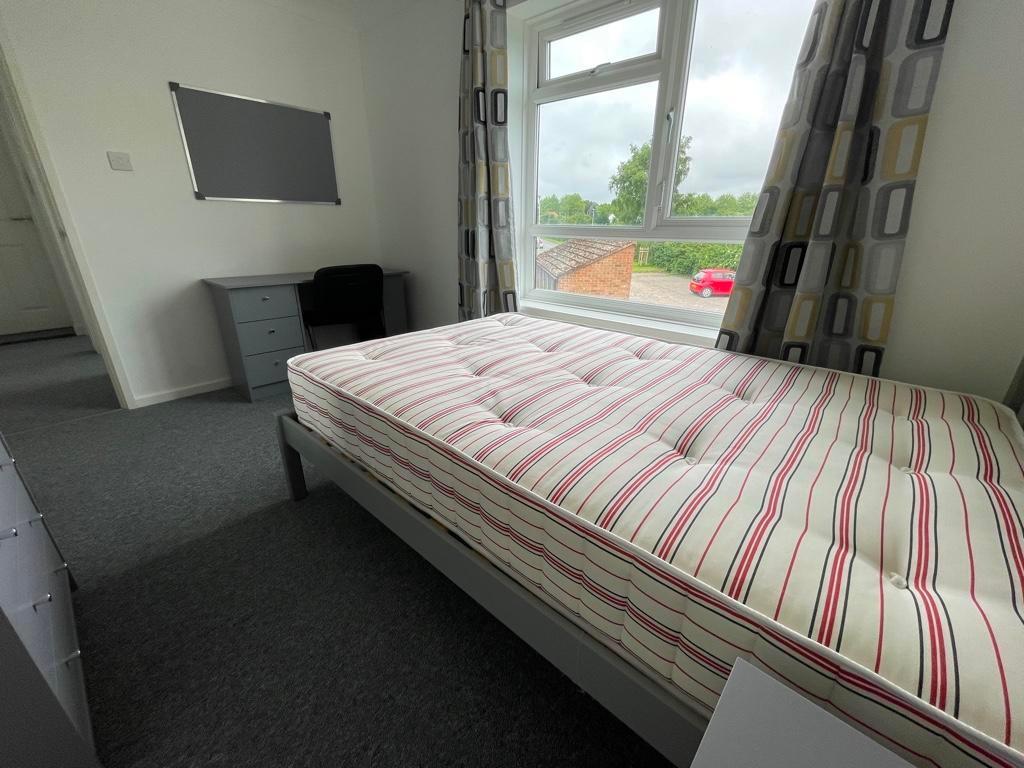 Bright, neatly presented bedroom with a comfort...