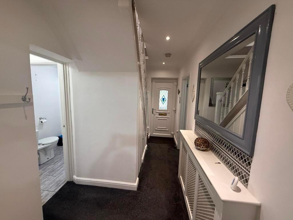 Bright, well-maintained entrance hallway with a...