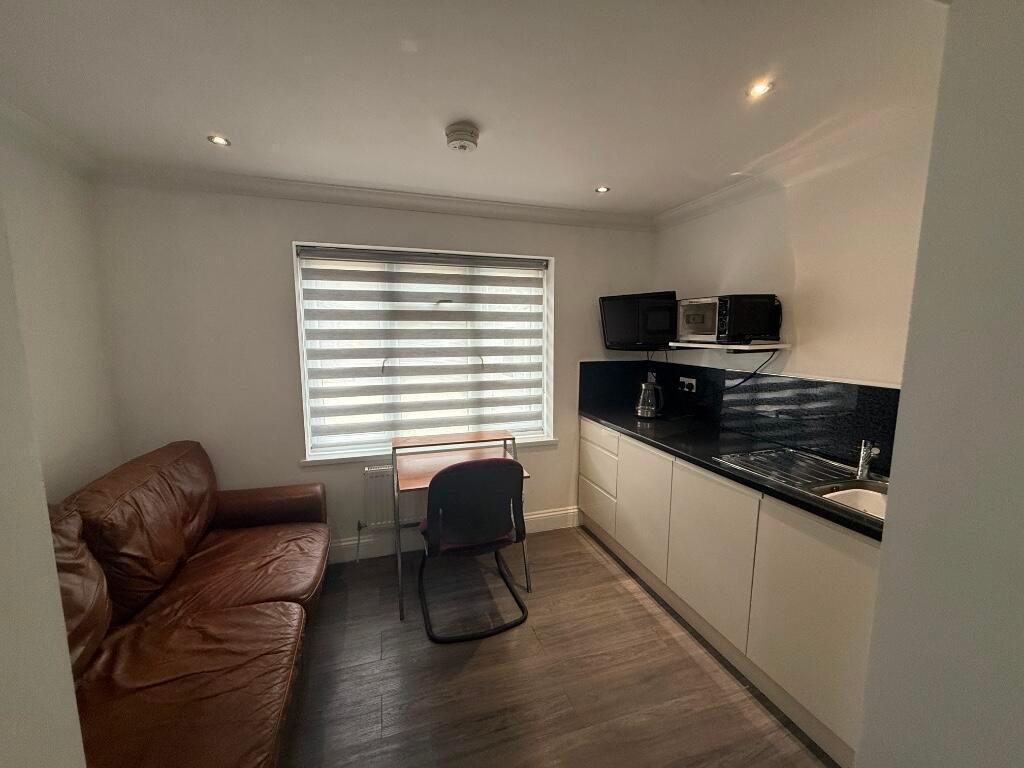 Bright, modern studio-style space with a fitted...