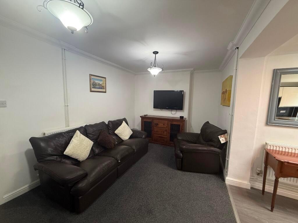 Well-presented living room with comfortable dar...