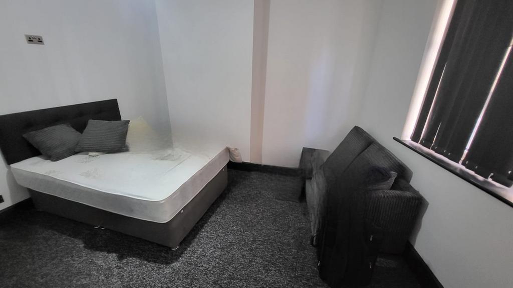 Simple, neutrally decorated bedroom with a doub...