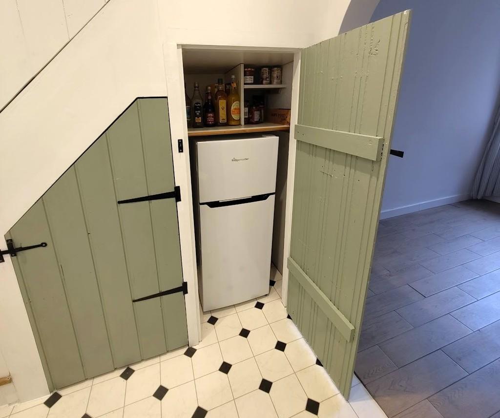 Under stair storage and fridge alcove