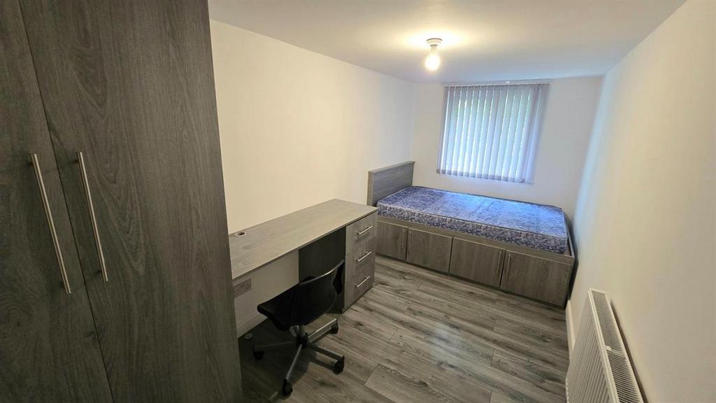Neat bedroom with a double bed, built-in storag...